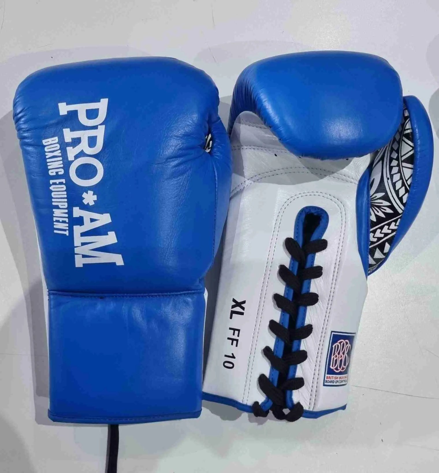 Pro-Am Undisputed professional boxing gloves by Proamboxinguk, BBBofC approved, featuring black and red design with padded wrist support.
