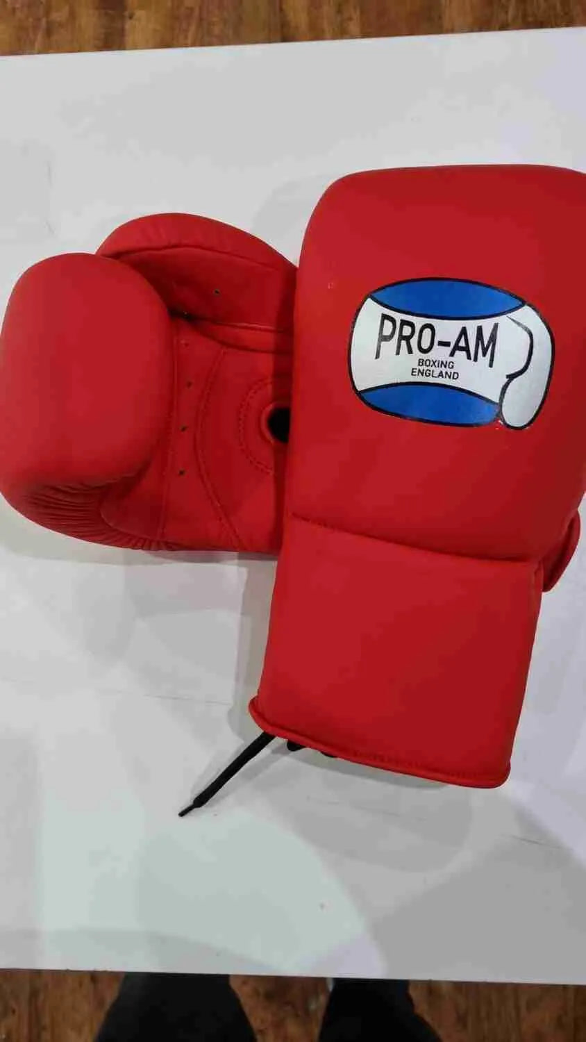 Pro-Am professional sparring boxing gloves with lace-up closure, black and red design for training and combat boxing.