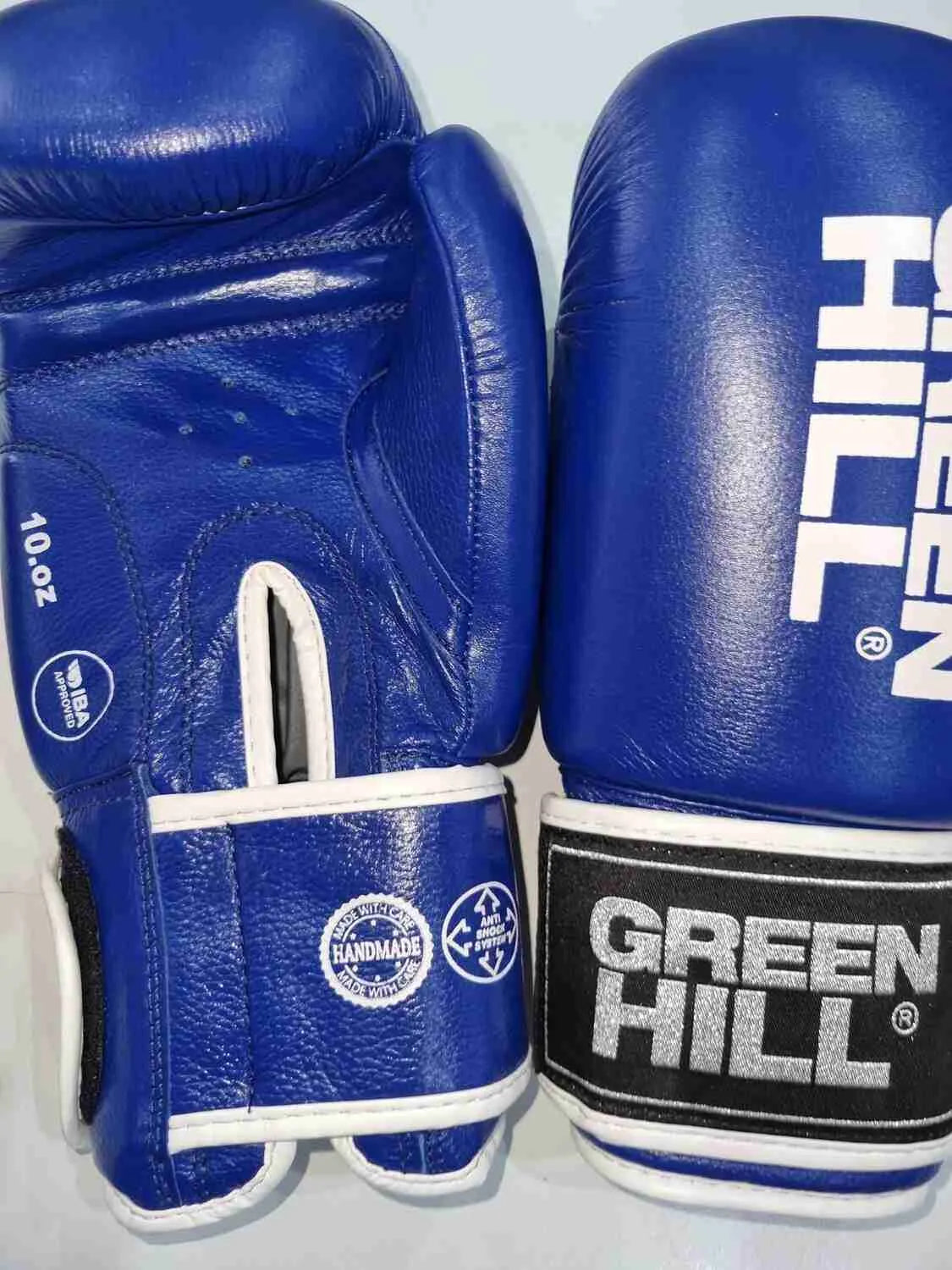 Greenhill IBA approved competition boxing gloves by Proamboxinguk, featuring green and black design with padded wrist support.