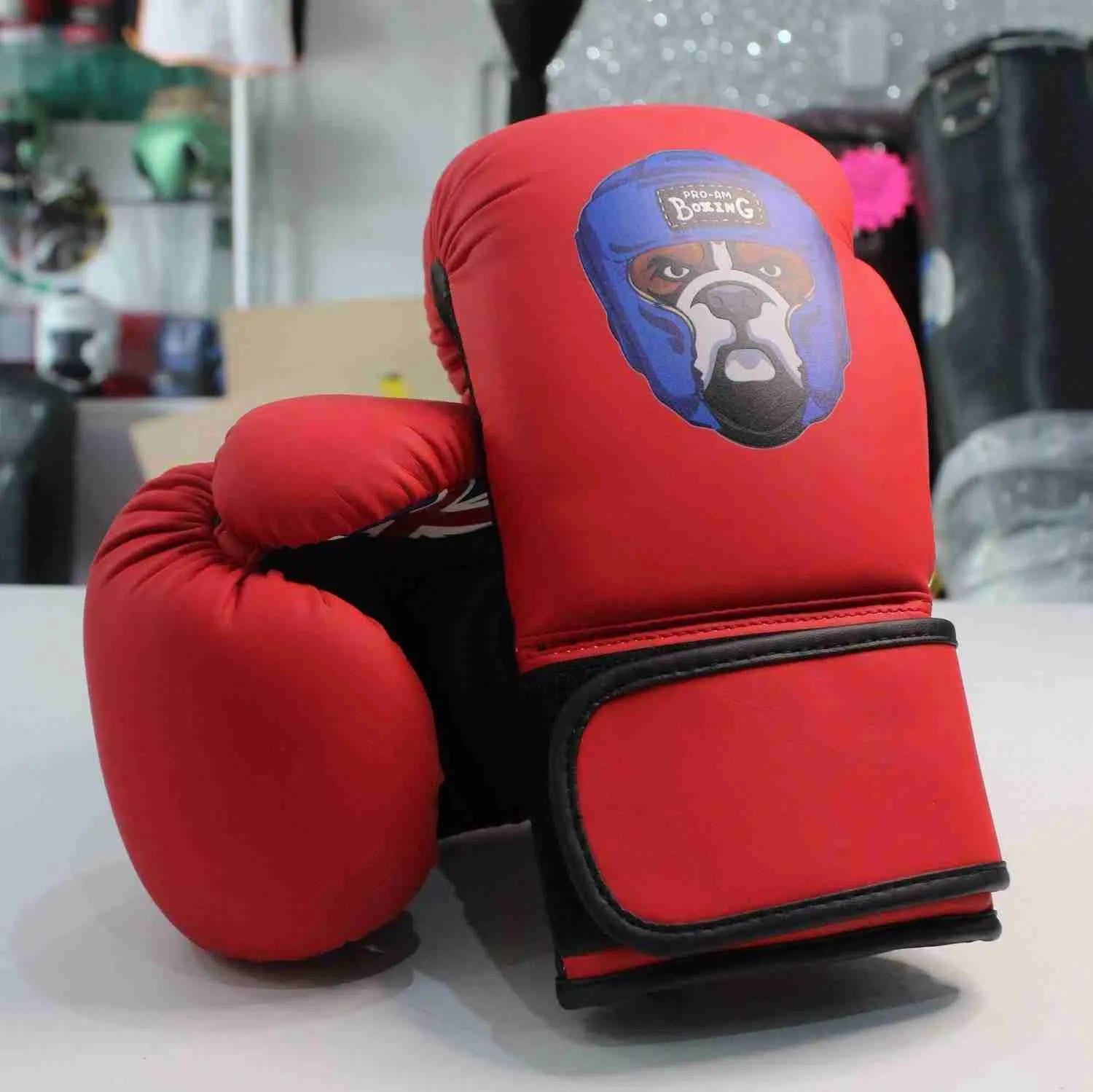 Kids boxing gloves by Proamboxinguk, colorful Pro-Am Kids Boxing Gloves with padded wrist support and secure Velcro straps.