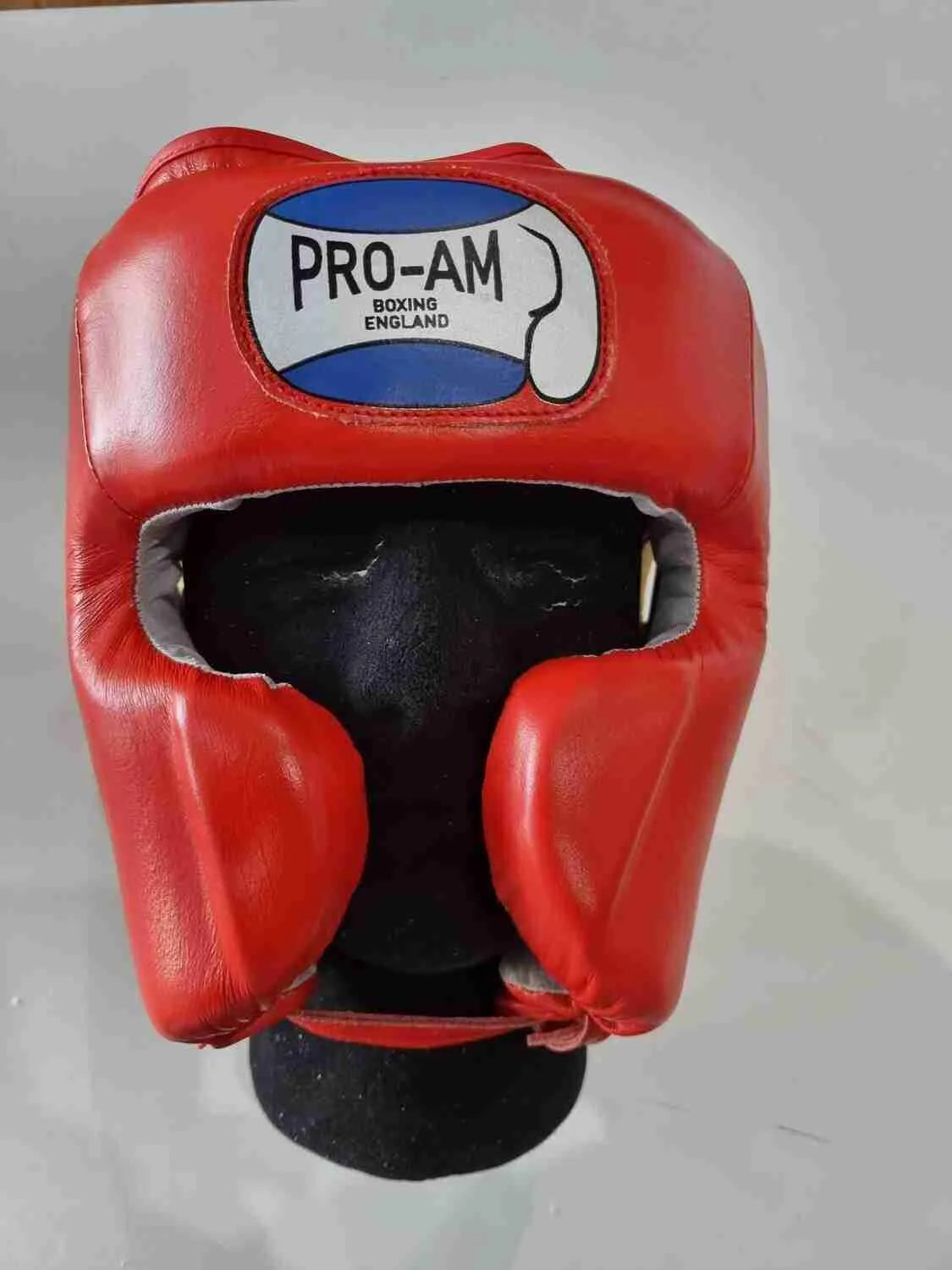 Pro-Am Professional Sparring Headguard by Proamboxinguk showing padded headgear with adjustable straps for boxing training.