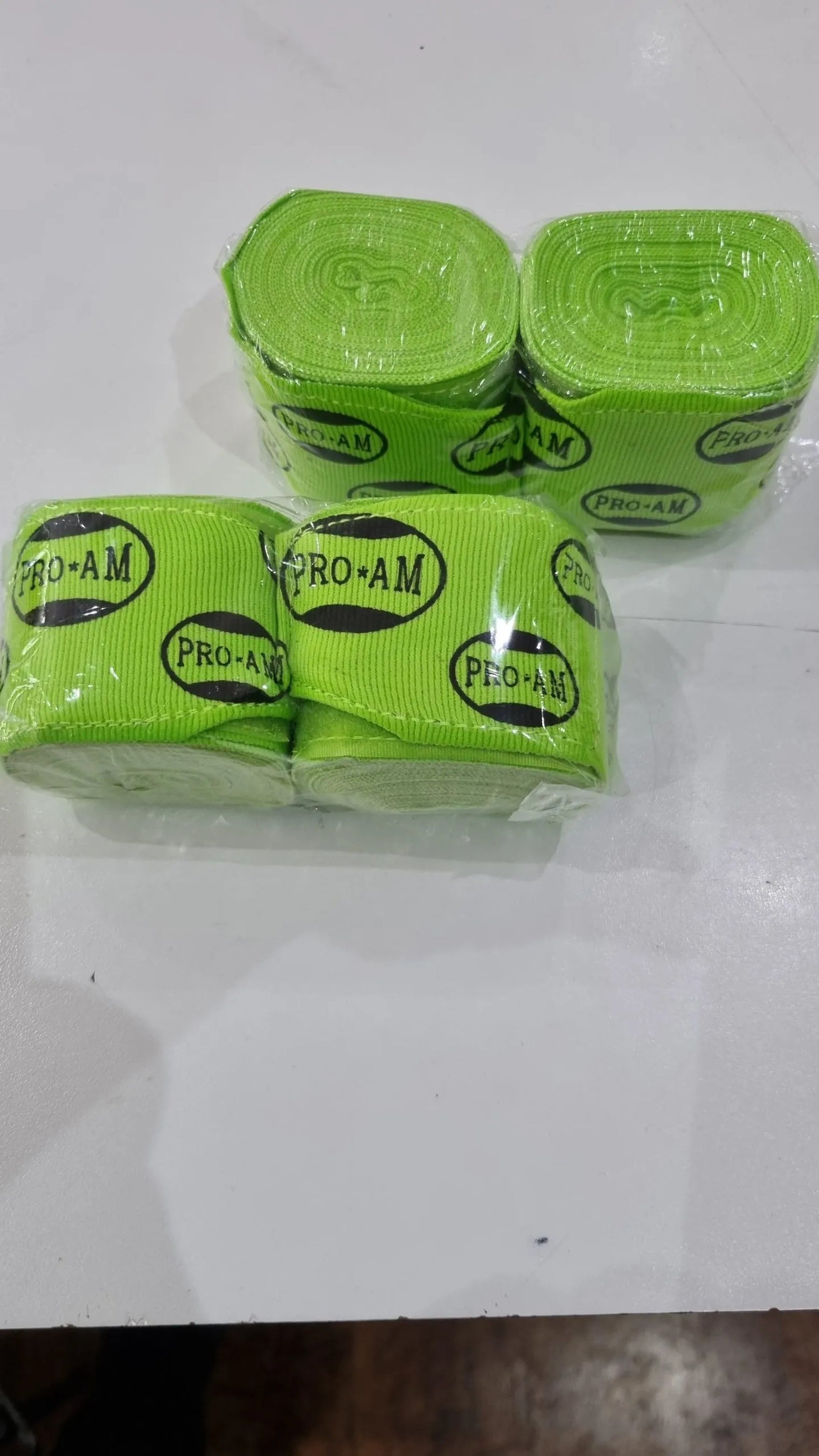 Pro-Am Stretch Boxing Hand Wraps by Proamboxinguk, showing black and white hand wraps designed for hand protection during boxing.