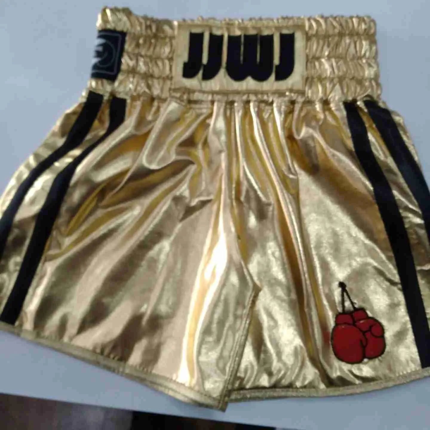 Custom boxing shorts by Proamboxinguk with personalized name and logo, featuring vibrant colors and athletic design.