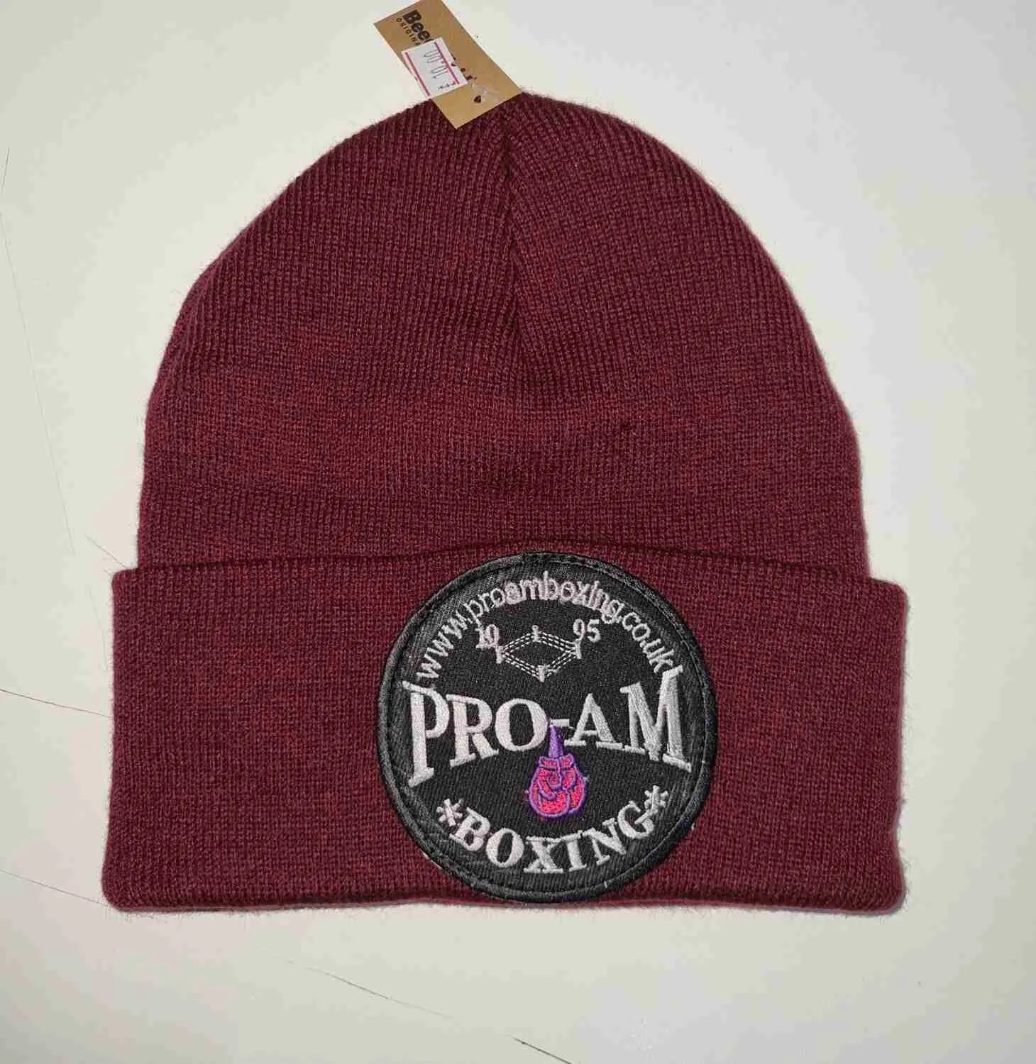 Pro-Am Boxing Beanie Hat by Proamboxinguk, soft knit fabric, black color, close-up view showing the branded logo and cozy fit.