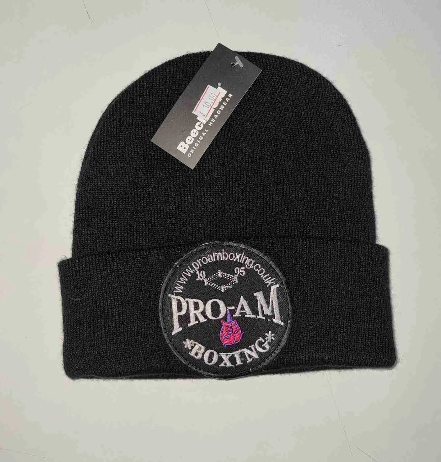 Pro-Am Boxing Beanie Hat by Proamboxinguk, soft knit fabric, black color, close-up view showing logo and cozy fit.