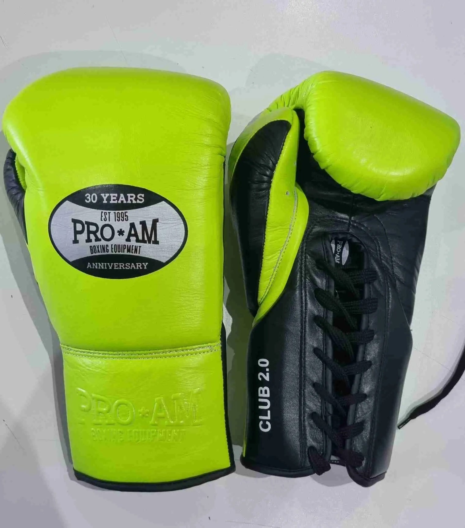 Pro-Am Club 2.0 lace-up training boxing gloves by Proamboxinguk, shown in black with padded wrist support.