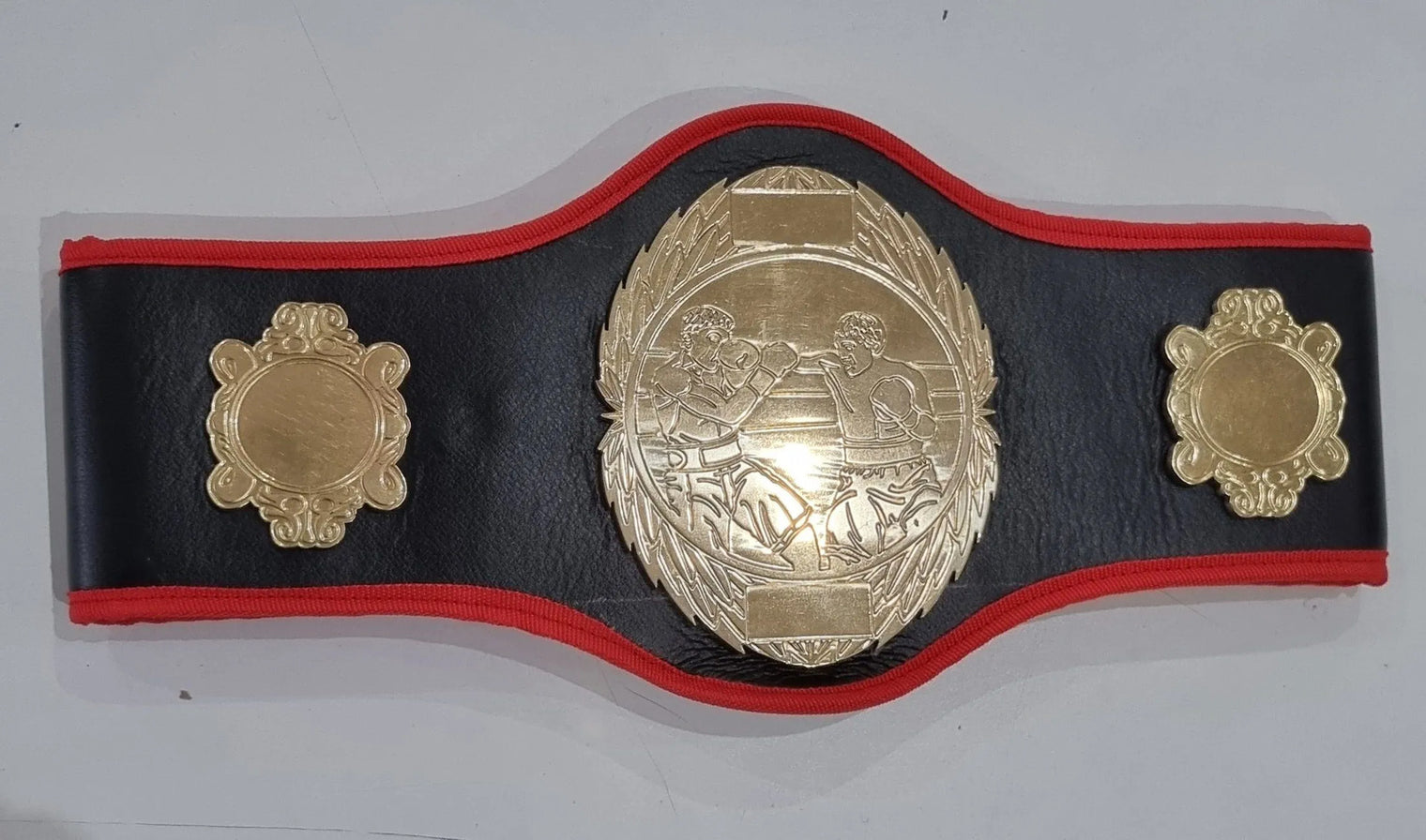 Pro-Am Champions boxing belt with custom award design, featuring engraved plaque and detailed leather strap, by Proamboxinguk.