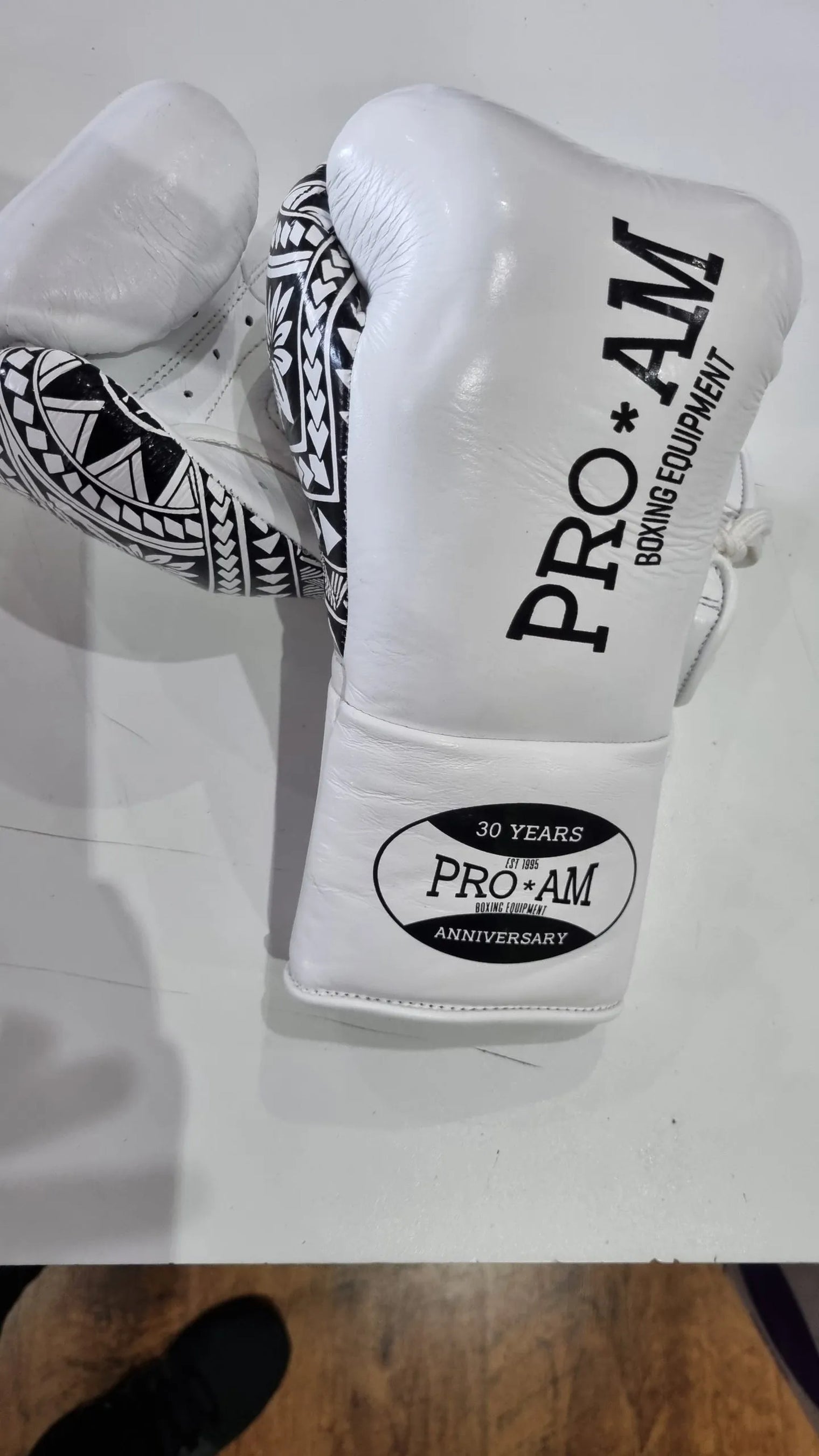 Proamboxinguk Valero professional boxing gloves with BBBofC approval, featuring black and red design and padded wrist support.