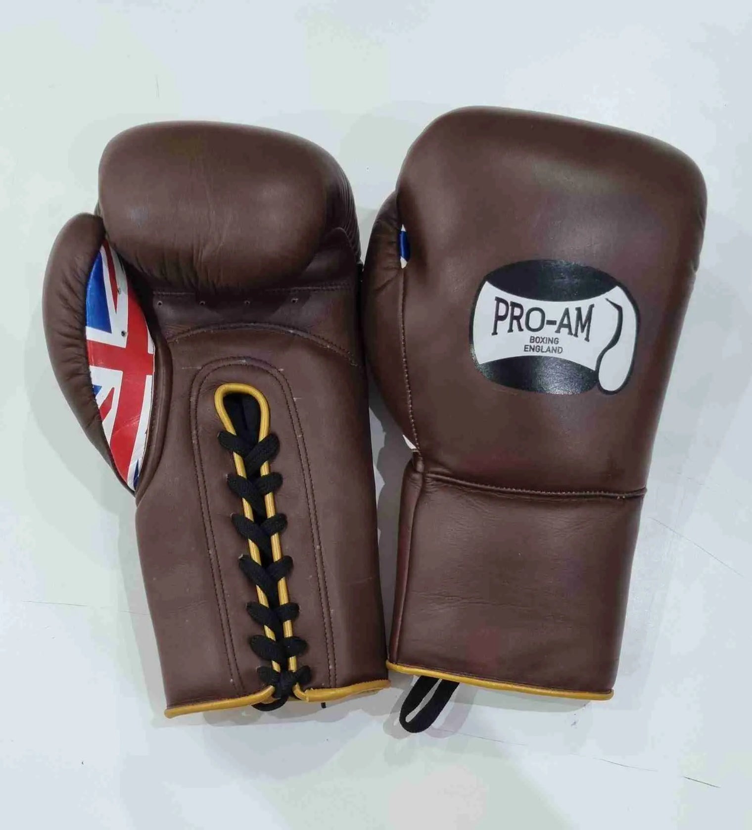 Pro-Am Professional Sparring Boxing Gloves by Proamboxinguk, lace-up design, padded for training and combat boxing.