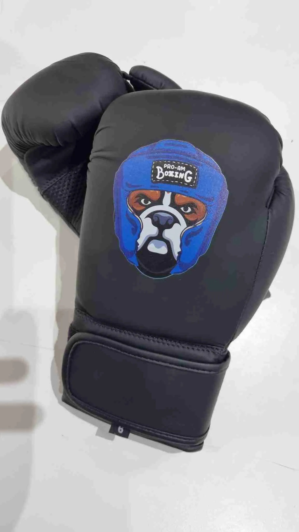 Kids boxing gloves by Proamboxinguk, colorful protective gloves for children, displayed on a white background.