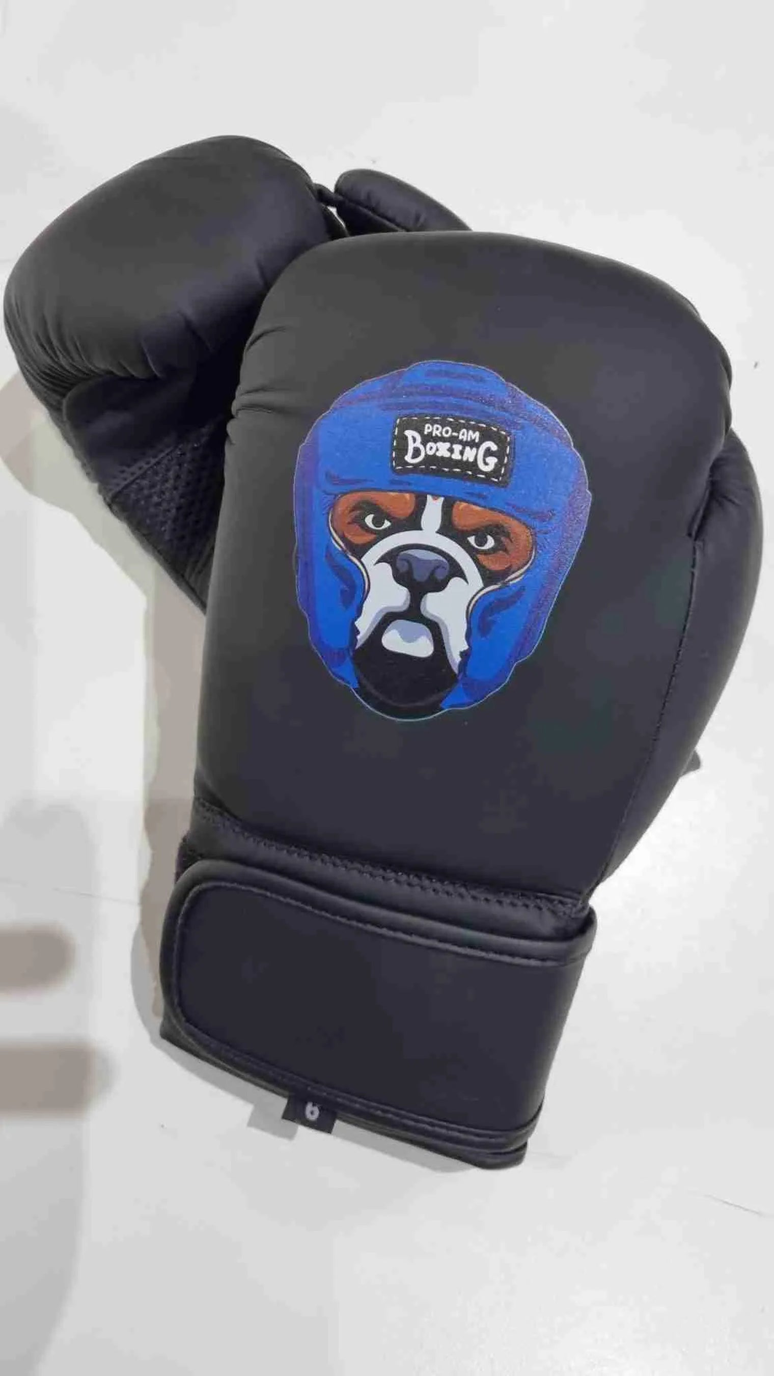 Kids boxing gloves by Proamboxinguk, colorful protective gloves for children, displayed on a white background.