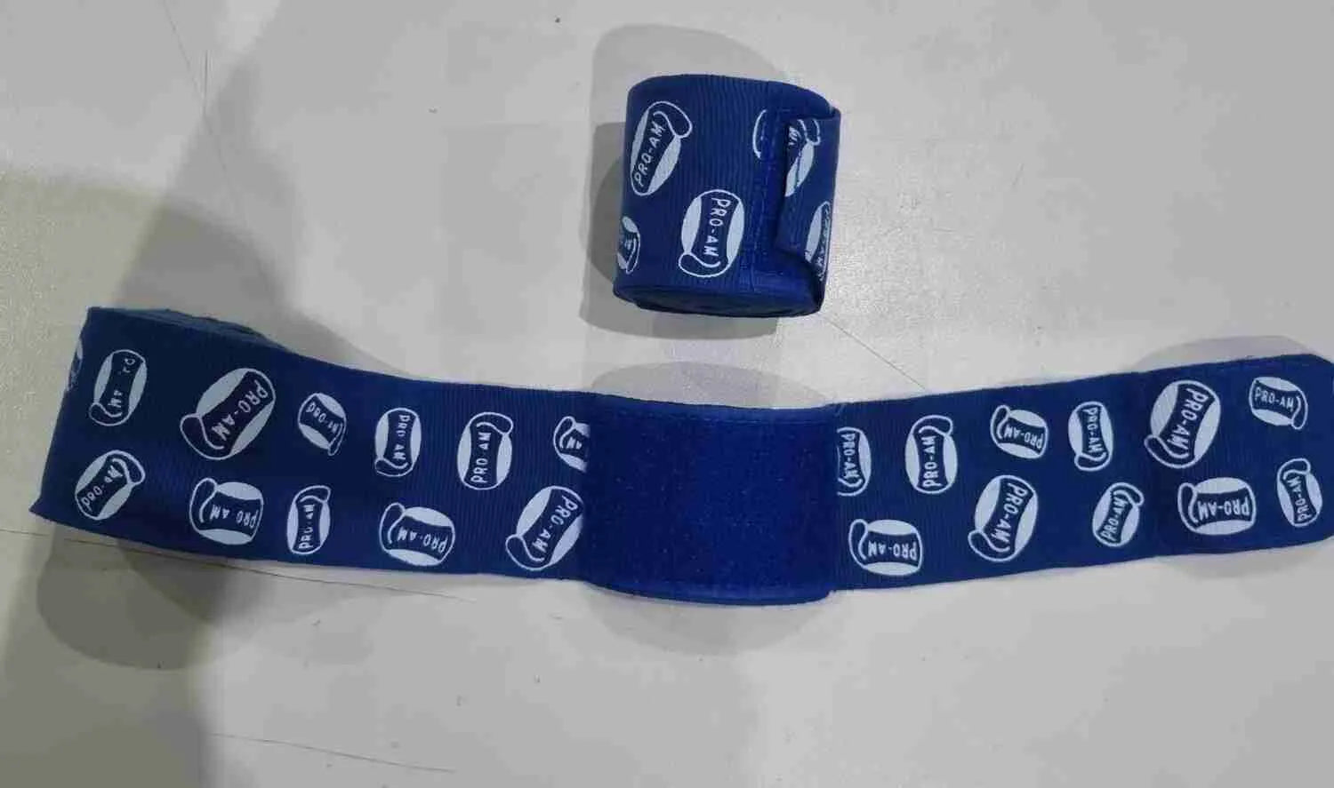 Pro-Am Stretch Boxing Handwraps by Proamboxinguk, showing black and red elastic hand wraps for boxing training and protection.