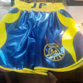 Custom boxing shorts with personalized name and logo, featuring durable fabric and vibrant design by Proamboxinguk.