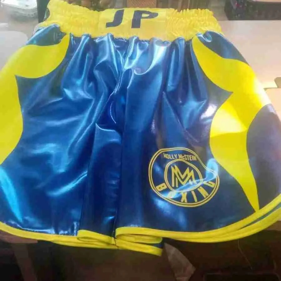 Custom boxing shorts with personalized name and logo, featuring durable fabric and vibrant design by Proamboxinguk.