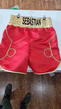 Custom boxing shorts by Proamboxinguk with personalized name and logo, featuring vibrant fabric and athletic fit.