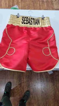 Custom boxing shorts by Proamboxinguk with personalized name and logo, featuring vibrant fabric and athletic fit.