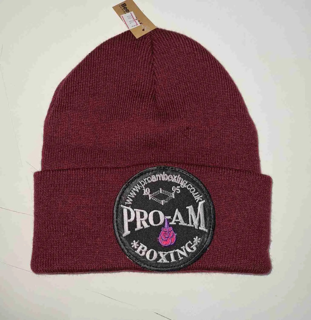 Pro-Am Boxing Beanie Hat by Proamboxinguk, soft knit fabric, black color, close-up view showing the branded logo and cozy fit.