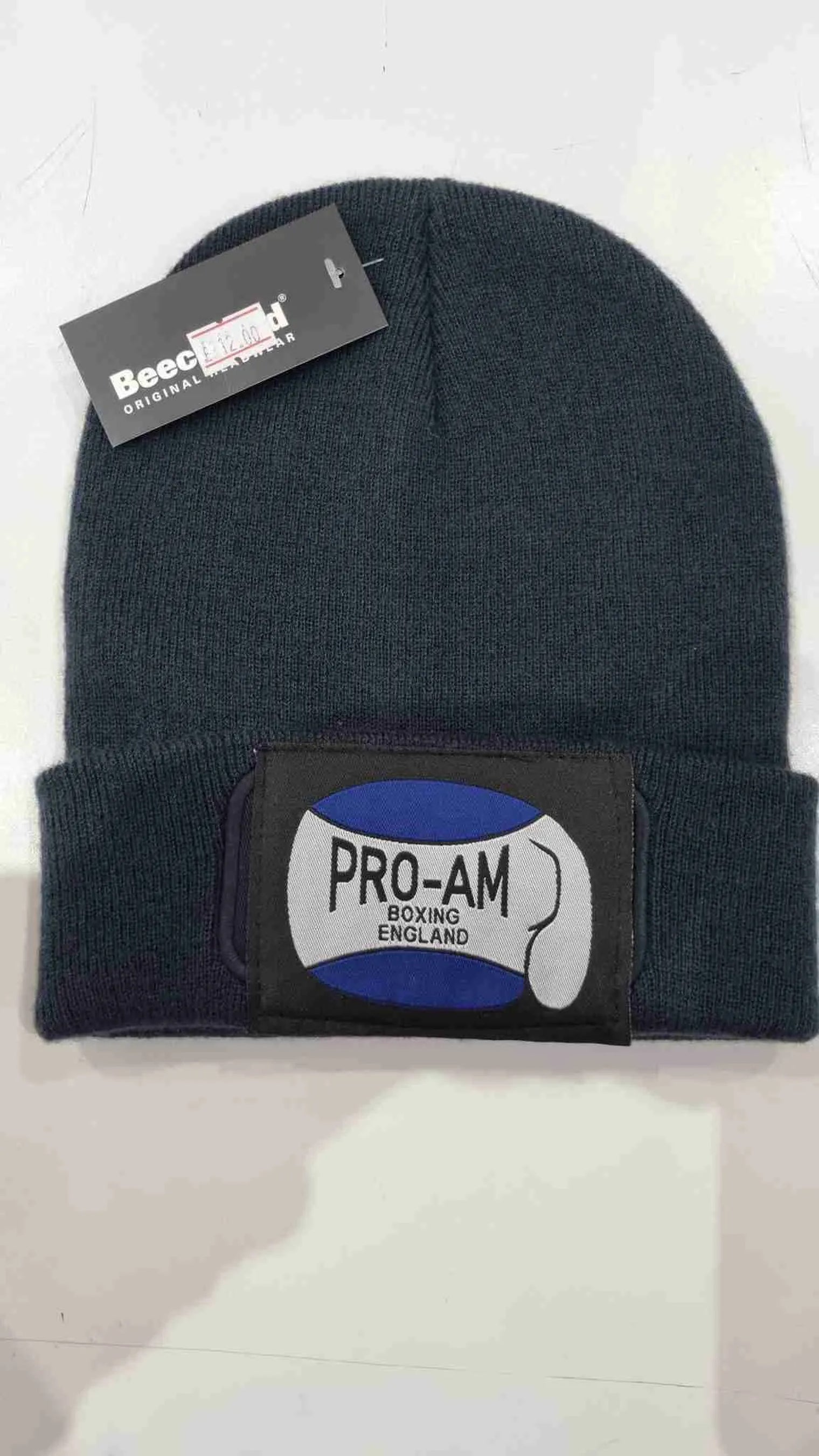 Pro-Am Boxing Beanie Hat by Proamboxinguk, close-up of black knit hat with folded cuff and logo branding.
