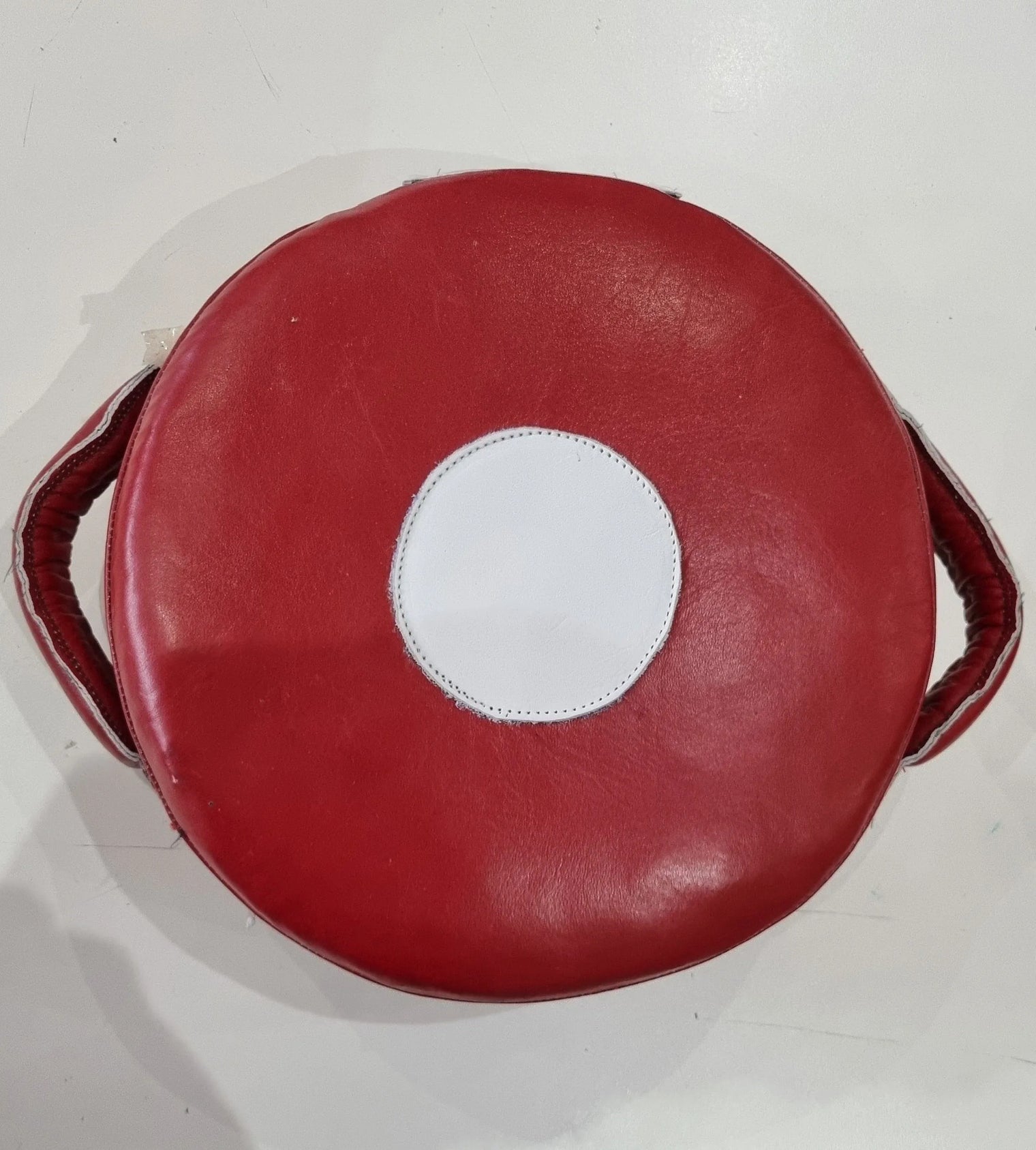 Small Mexican leather punch shield by Proamboxinguk, showcasing durable leather and sturdy handle for boxing training.