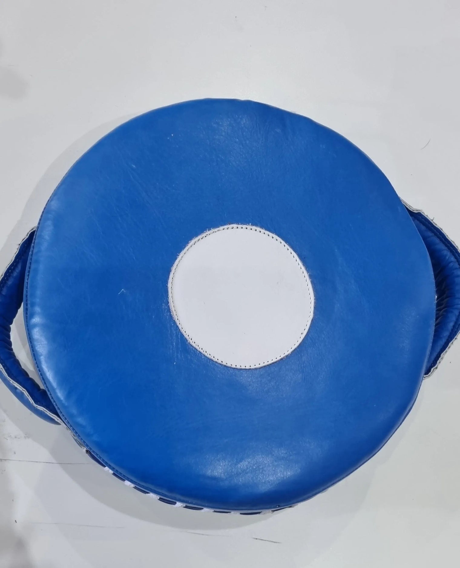 Small Mexican leather punch shield from Proamboxinguk, featuring durable leather with reinforced handles for boxing training.